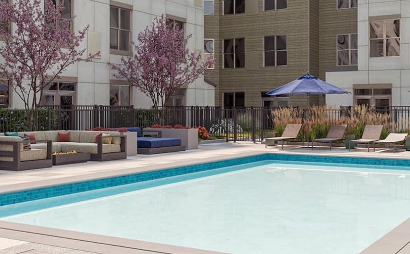 swimming pool with spacious seating areas and reclining chairs